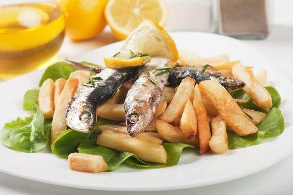 Peixe sardinha grelhado com batatas fritas — Fotografia de Stock