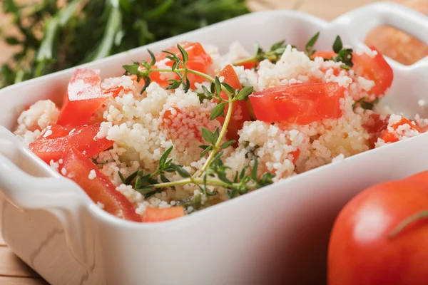 Tasty couscous with herbs ant fresh tomato — Stock Photo, Image
