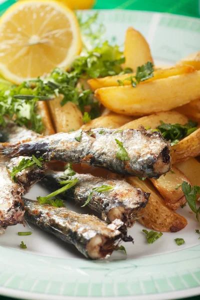 Pesce sardina alla griglia con zeppe di patate — Foto Stock