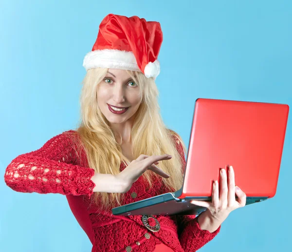 The young beautiful blonde woman in a New Year's hat with red laptop — Stock Photo, Image