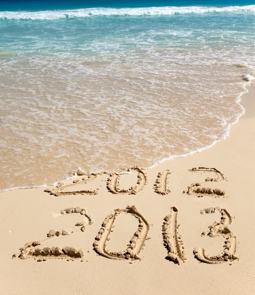 New 2013. The wave washes off an inscription 2012. — Stock Photo, Image