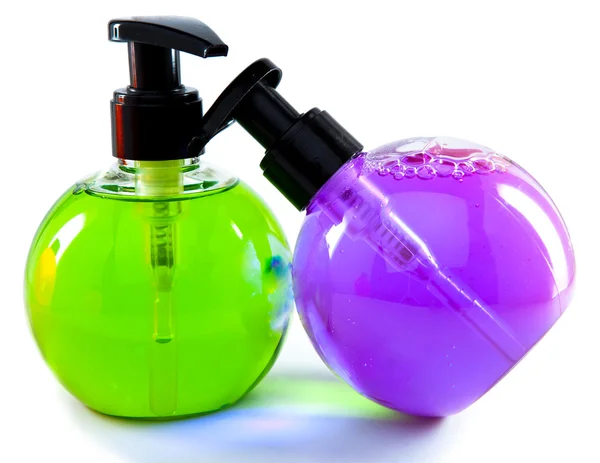 Duas pequenas garrafas cosméticas a cores brilhantes com o distribuidor — Fotografia de Stock