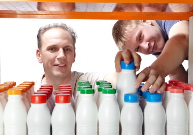Men selects dairy products in the shop clipart