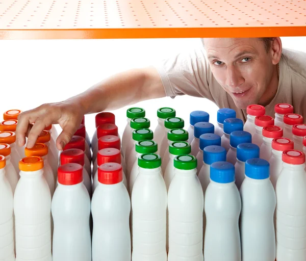 The man selects dairy products in the shop — Stock Photo, Image