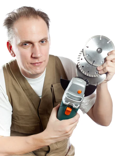 The man, the builder, chooses a detachable disk for the tool — Stock Photo, Image