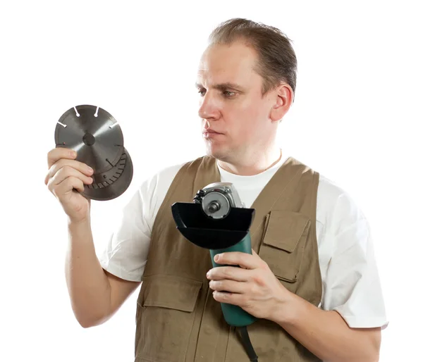 The man, the builder, chooses a detachable disk for the tool — Stock Photo, Image