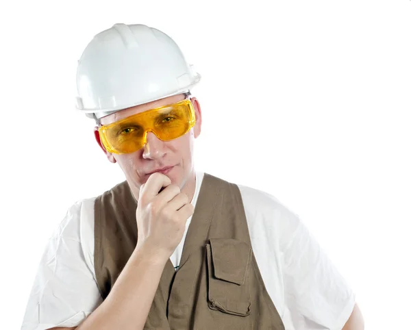 The man, the builder, in goggles and a helmet — Stock Photo, Image