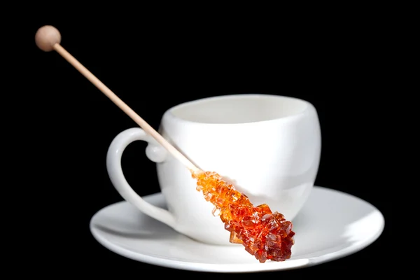 Coffee cup and candy sugar on a stick — Stock Photo, Image