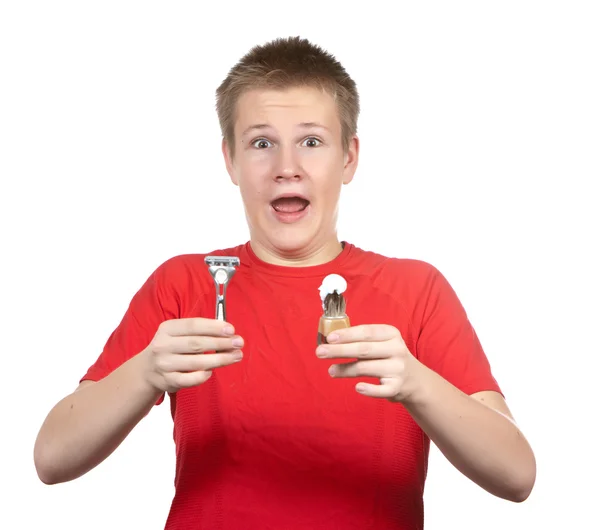 The boy, the teenager the first time tries to have a shave and is confused. — Stock Photo, Image