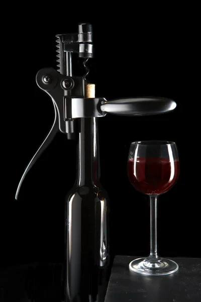 Bottle with an opener and a wine glass — Stock Photo, Image
