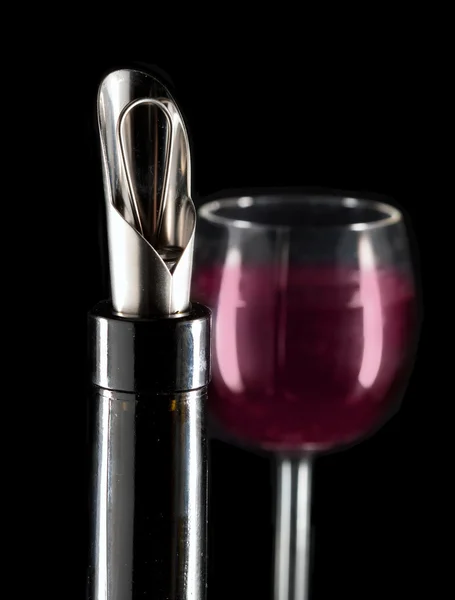 Bottle with a special nozzle for wine pouring and a wine glas — Stock Photo, Image