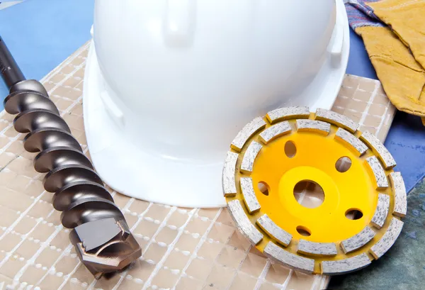 Diamond discs for cutting of tile and a helmet on a tile — Stock Photo, Image