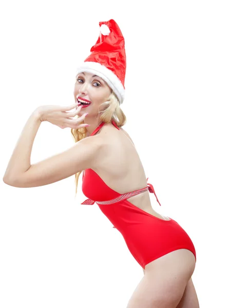 The beautiful woman in a red bathing suit and a red cap of Santa Claus — Stock Photo, Image