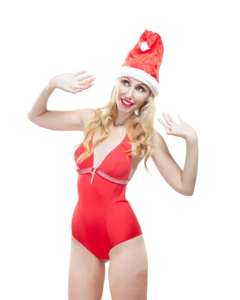 The beautiful woman in a red bathing suit and a red cap of Santa Claus — Stock Photo, Image