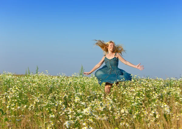 The happy young woman in the field of camomiles Royalty Free Stock Images