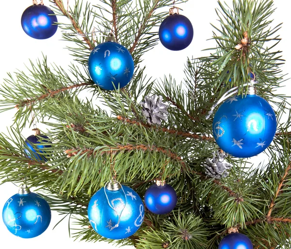 New Year's balls on branches of a Christmas tree and gifts Stock Image