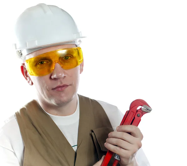 The man, the builder, in goggles and a helmet. — Stock Photo, Image