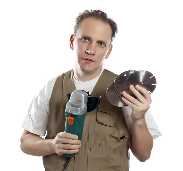 L'homme en combinaison de travail avec la machine amovible et les disques de scie — Photo