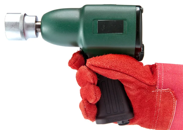 Hand in a working glove holds air impact wrench — Stock Photo, Image
