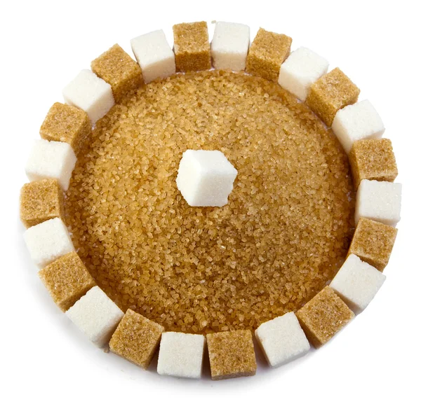 Cubes of sugar lie on circles and a heap of granulated sugar inside — Stock Photo, Image