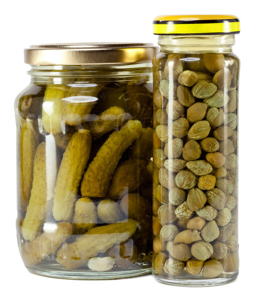 Glass jar with tinned capers and cucumber
