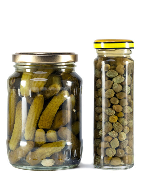 Glass jar with tinned capers and cucumber