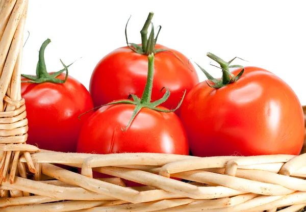 The ripened tomatoes in a wattled basket — Stock Photo, Image