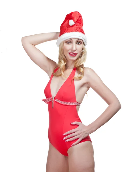 The beautiful woman in a red bathing suit and a red cap of Santa Claus — Stock Photo, Image