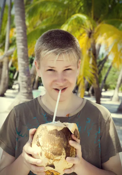 Smiling teenager with coconut,with a retro effec — Stock Photo, Image