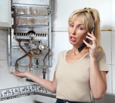 The young woman the housewife calls in a workshop on repair of gas water heater clipart