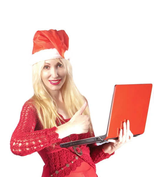 The young beautiful woman in a New Year's hat with red laptop — Stock Photo, Image