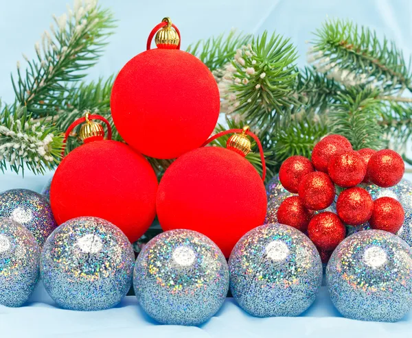 Red New Year's balls and branches with the snow — Stock Photo, Image