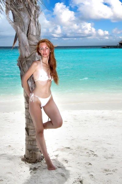 The young beautiful woman on a beach — Stock Photo, Image