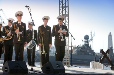 Military band musicians perform on a city holiday, devoted to the 150th anniversary of Petrovsky park in August 27, 2011 in Kronstadt, Russia clipart