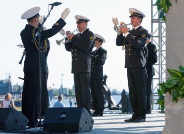 military band musicians perform on a city holiday, devoted to the 150th anniversary of Petrovsky park in August 27, 2011 in Kronstadt, Russia clipart