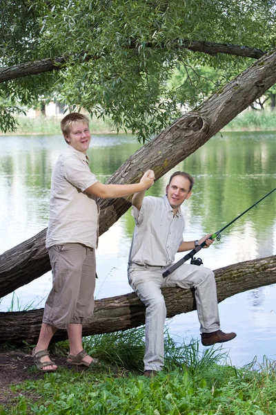 The father with the son on fishing. Rejoice to a biting — Stock Photo, Image