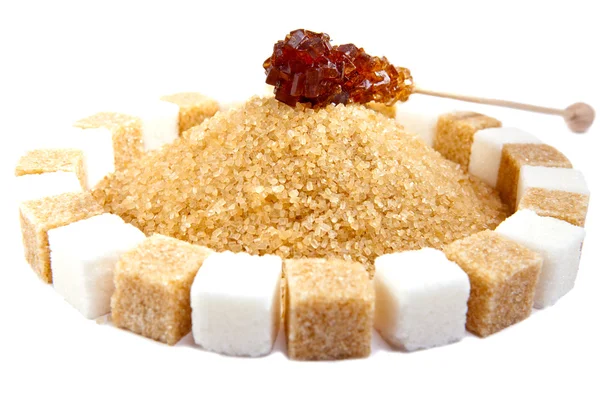 Candy sugar on a stick on a heap of granulated sugar — Stock Photo, Image