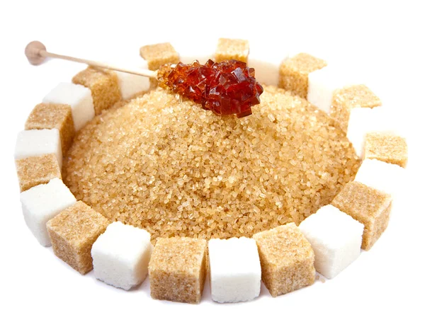 Sugar cube on a heap of granulated sugar — Stock Photo, Image