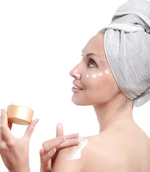 The beautiful young woman in towel with a cosmetic cream — Stock Photo, Image