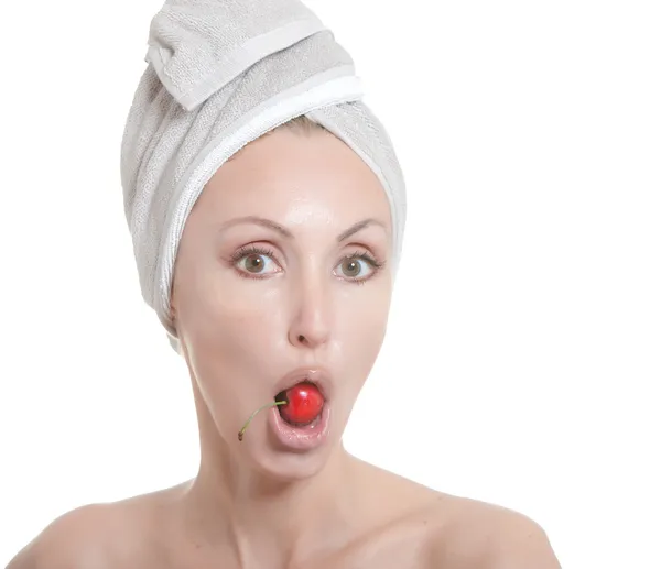 Beautiful young woman in towel, with a cherry berry — Stock Photo, Image