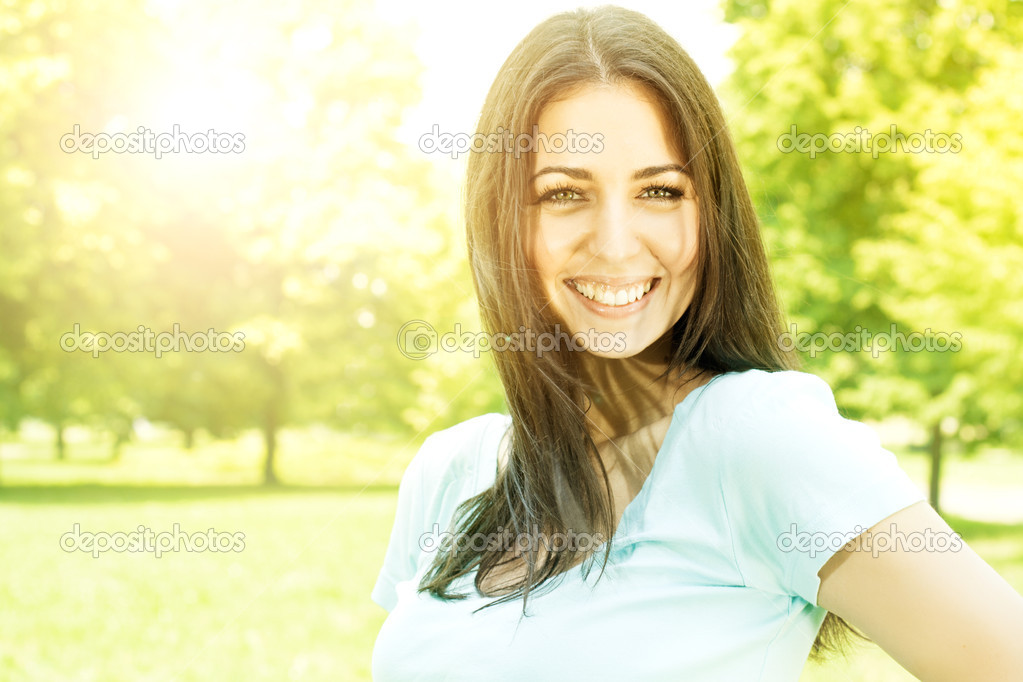 happy young woman enjoying on beautiful spring day in park