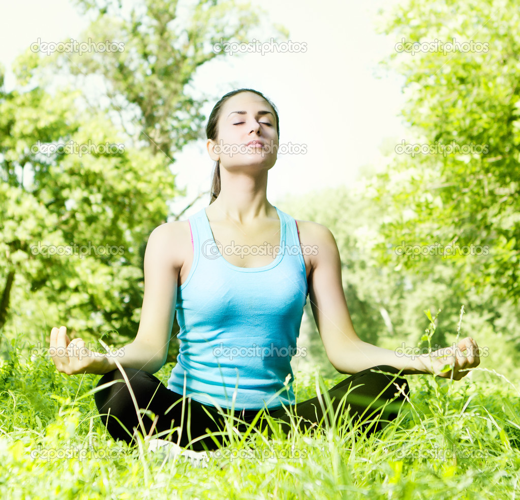 Young woman meditating in the park