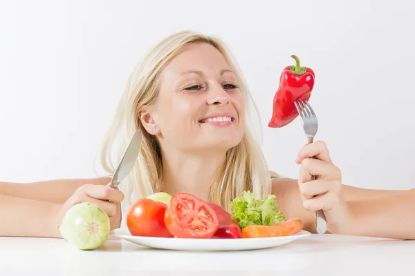 Happy woman eating vegetable Stock Image