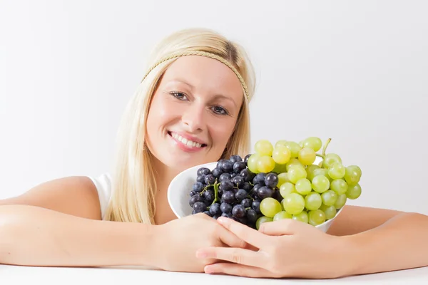 Aantrekkelijke blonde vrouw bedrijf druiven — Stockfoto