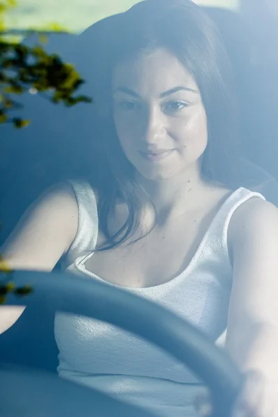 Hermosa mujer joven conduciendo un coche — Foto de Stock