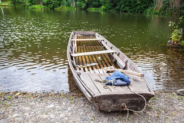 Övergiven Träfiskebåt Sjöns Strand Reflektion Över Vatten — Stockfoto