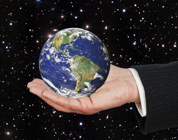 Planet earth on palm.Elements of this image furnished by NASA