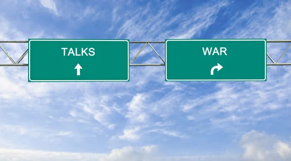 Road signs to war and talks — Stock Photo, Image