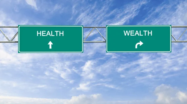 Road sign to health and wealth — Stock Photo, Image