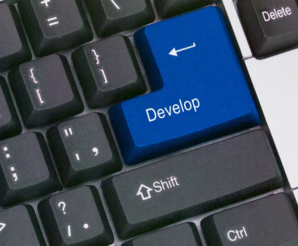 Toetsenbord met sleutel tot ontwikkeling — Stockfoto